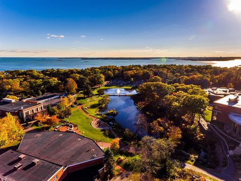 sunny aerial shots of campus with ocean on the horizon