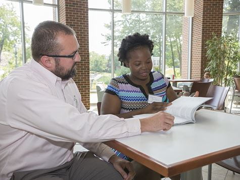 a support center faculty member helping a student